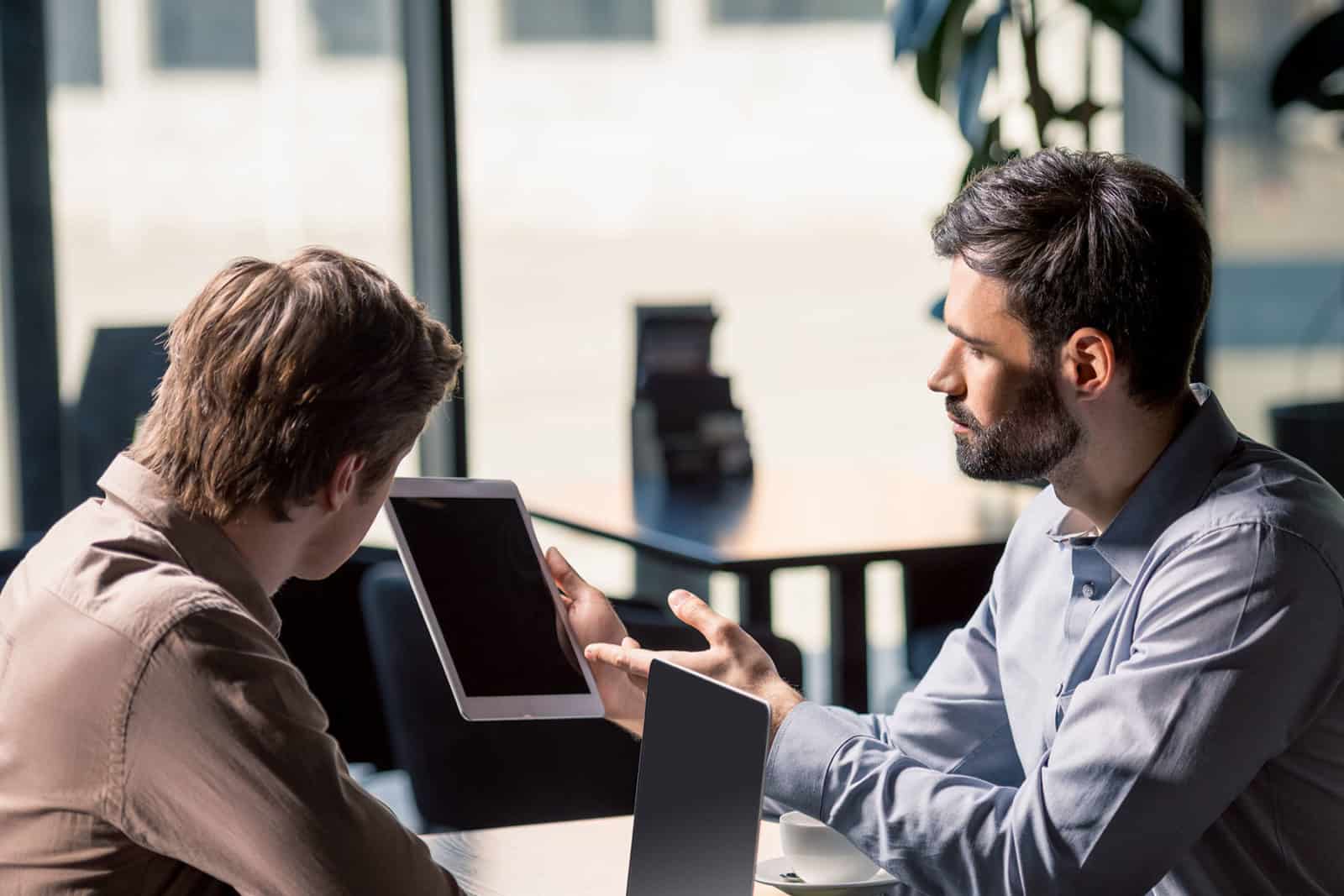 Decision making principles - two men discussing work
