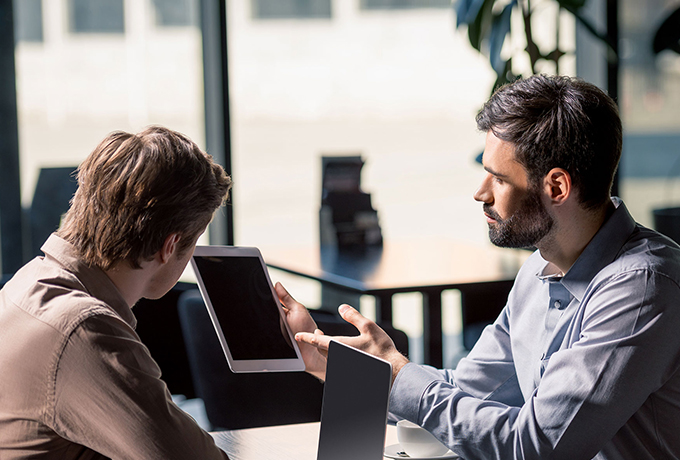 Decision making principles - two men discussing work