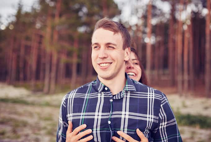 Man and women laughing together whilst walking