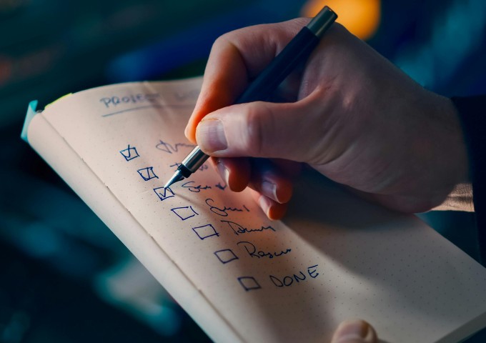 Hand writing on notebook with checklist