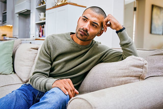 What is depression? Sad man sitting on couch