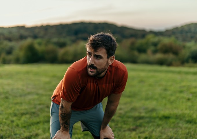 Man taking a rest whilst exercising outdoors