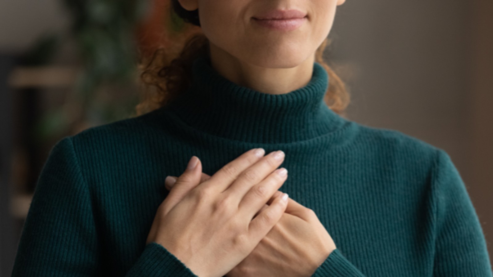 Woman taking a breath with her hand on her chest